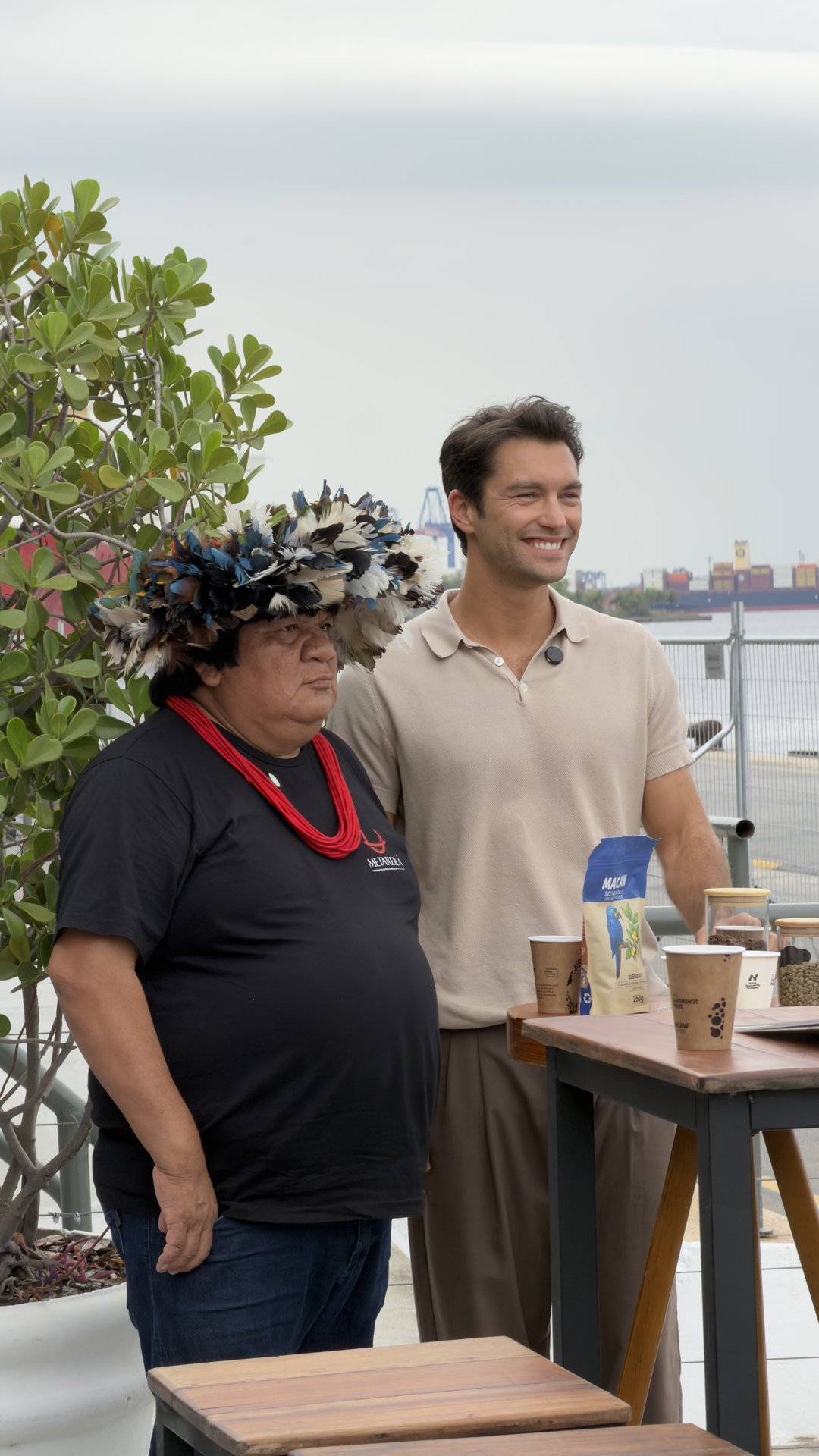 Lucas Garcez with an Indigenous leader at the Macaw stand