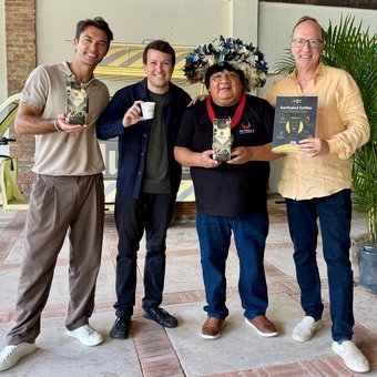 Lucas Garcez, Marcelo Gregorio, an Indigenous leader and David Fein with Earthshot Coffee bags